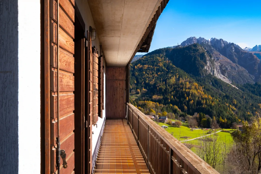 Terrace with panoramic Dolomites view and morning sunlight, perfect for breakfast outdoors.